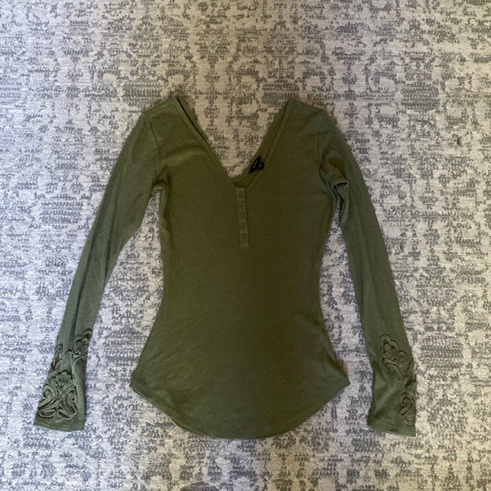 Deep V-neck, army green,thermal, long sleeve shirt, features elegant detail.